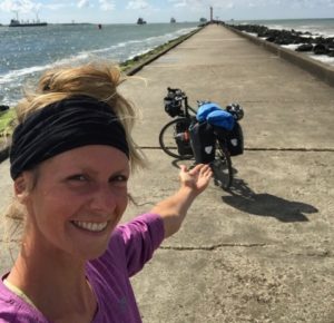 Maria mit ihrem Fahrrad am Ziel ihrer Radtour: die Rheinmündung bei Hoek van Holland